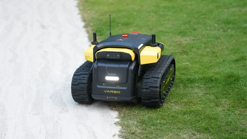Yarbo Core robot on a lawn next to a gravel path