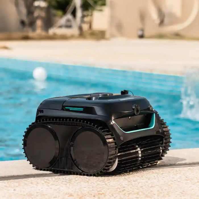 WYBOT cordless robotic pool cleaner at the edge of a backyard pool