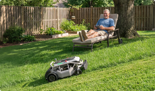 Homeowner on a lounge chair steering the Mowrator