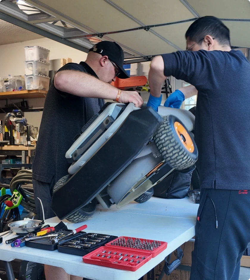 Mowrator technicians servicing a mower