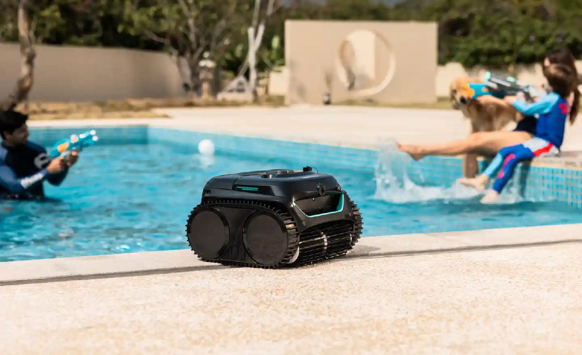 Kids playing in a pool while a WYBOT cleaner works nearby