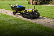 Yarbo Core towing a garden cart along a stone path