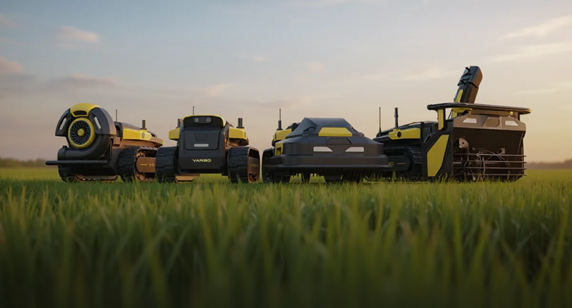 Yarbo Core and modules lined up on a lawn at dusk