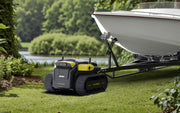 Yarbo Core moving a boat trailer on a lawn